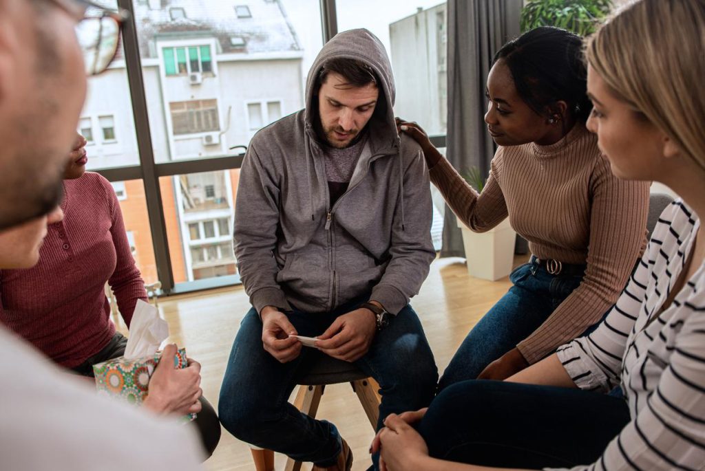 A man at a Group Intervention with his Loved ones in St. Paul, Minnesota